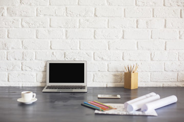 Black laptop screen on desktop