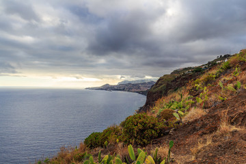 Fototapeta na wymiar Funchal coastline under the typical cloudy sky before sunset.