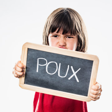 fighting little boy showing a school slate in the foreground