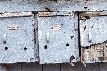 three very old and grungy mailboxes