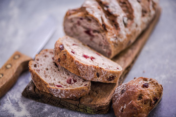 cutting slice of bread from loaf