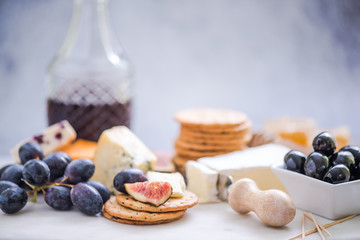 cheese board with grapes,wine,fig and olives