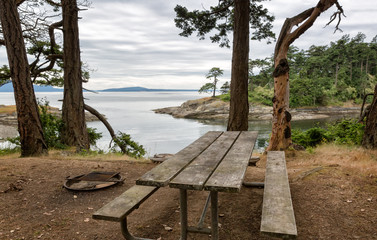 Picnic table and fire pit in a picturesque nature waterfront setting