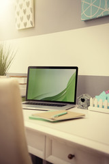 Stylish workplace with laptop at home, closeup