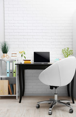 Stylish workplace with laptop at home