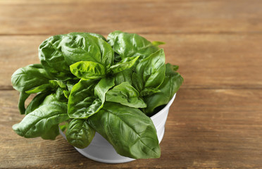 Fresh bunch of basil on wooden table