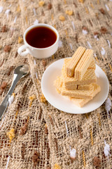 Wafer biscuits served with tea.