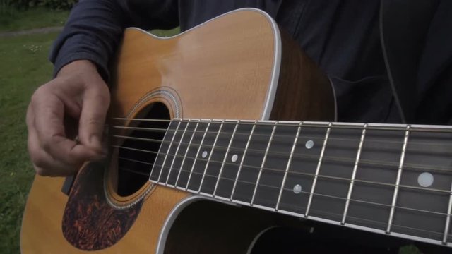Male Playing The Acoustic Guitar In Slow Motion