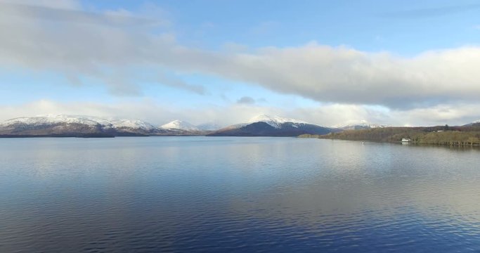 Aerial: Loch Tay in the Scottish Highlands during a clear winters day with snow on Ben Lawers, Scotland