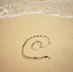 Email symbol draw on beach