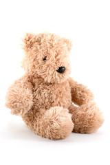 Fluffy teddy bear wearing a red Santa hat