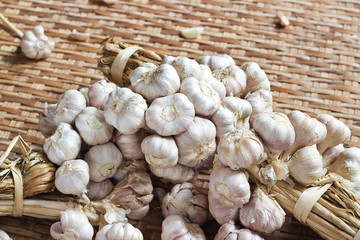 Garlics on a natural bamboo basket background