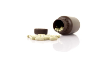 Herbal medicine capsules on white background.