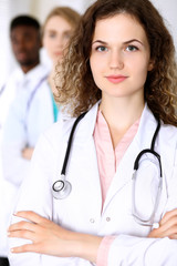 Happy doctor woman  with medical staff at the hospital