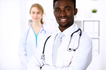 Happy african american male doctor  with medical staff at the hospital