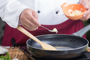 Chef putting minced garlic for cooking Pad Thai