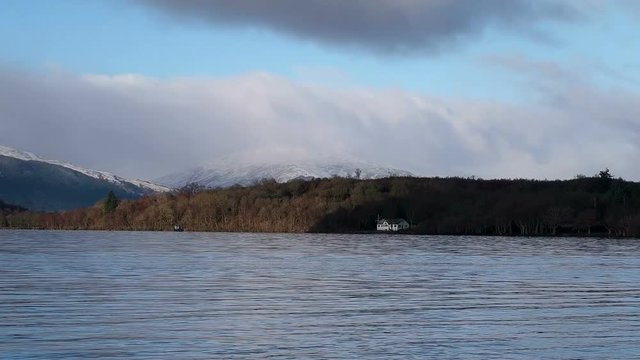Aerial: Loch Tay in the Scottish Highlands during a clear winters day with snow on Ben Lawers, Scotland