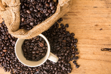 coffee bean with bean sack and cup on wood background