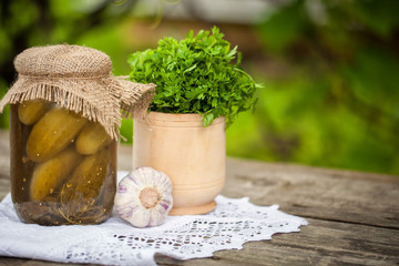 pickles, parsley, garlic on a wooden table