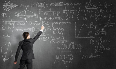 Man writing on blackboard