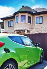 New American dream home with a beautiful blue sky in background and brand new car parked outside.