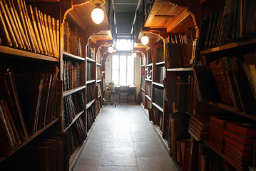 Old books on library shelves