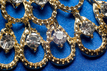 Golden Necklace on Blue Background