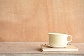 Cup of coffee with foam on wooden table