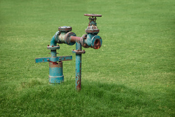 Water pipe on green grass meadow