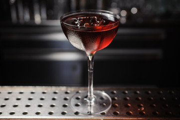 dark cocktail on a  bar setting