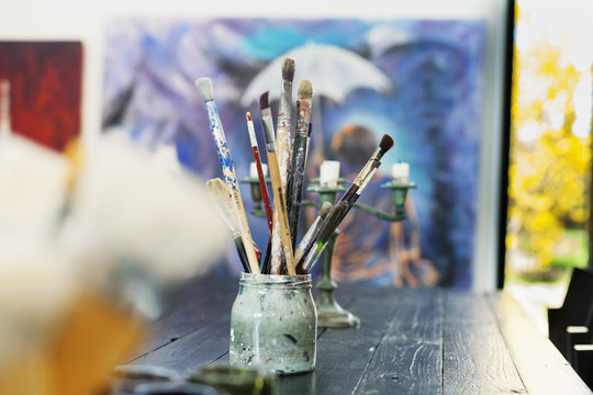 Paintbrushes in container on table at art studio