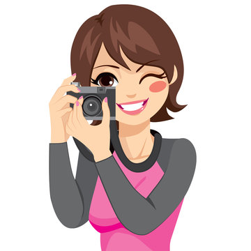 Beautiful happy smiling photographer woman taking photo using old retro analog camera