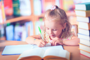 Portrait of an adorable baby girl wearing glasses on the table