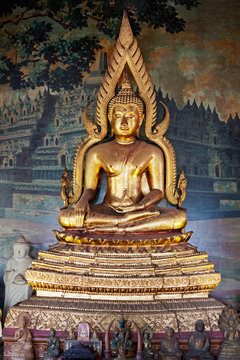 Gilded figure of Buddha in the temple. Indonesia