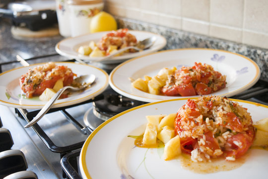 dishes of stuffed tomatoes with rice