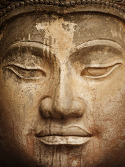 Fototapeta na wymiar Ancient stone Buddha face close up
