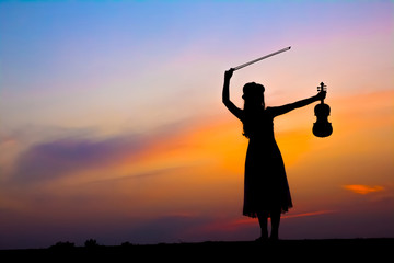 The silhouette of asian woman with the violin