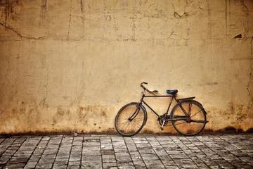 Acrylic prints Bike Old vintage bicycle near the wall