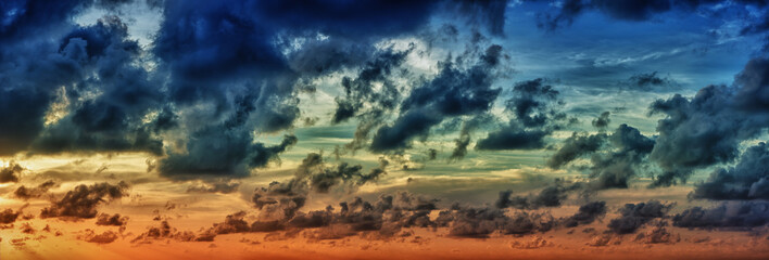 Fototapeta na wymiar Panoramic view of evening dramatic sky at sunset