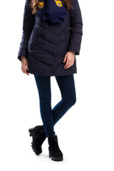 Woman in dark down jacket. Navy pants and black boots. Fashionable winter clothing. Warm footwear...