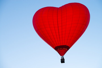 Fototapeta premium balloon in the form of heart against a blue sky at sunset