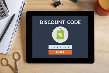 Discount code concept on tablet screen with office objects. All screen content is designed by me
