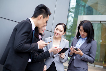 Group of business discuss on cellphone