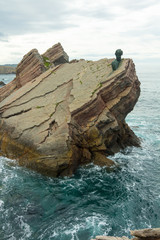 Monument on the rocks by the sea of Philippe Cousteau, Gijon, Spain