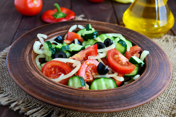 Dietary salad with vegetables, olives and oil. Mediterranean Kitchen.