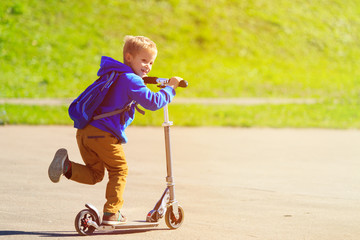 happy little boy riding scooter, active kids © nadezhda1906
