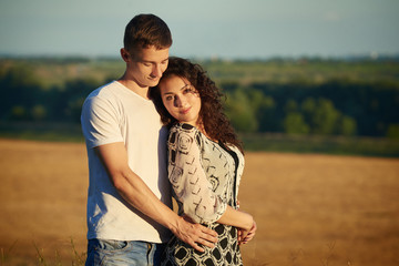 happy young couple posing high on country outdoor, romantic people concept, summer season