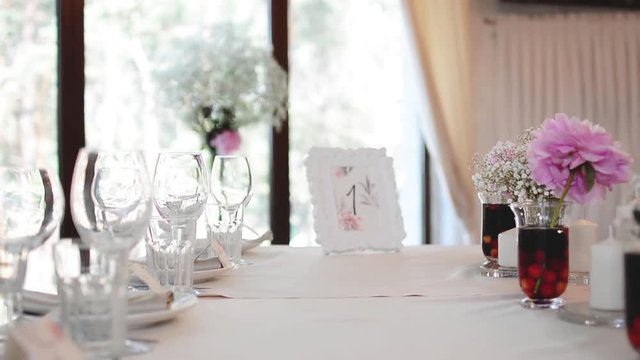 Modern Wedding Decorated Table. Frame with Numbers.  Place setting and card on a table at a wedding reception