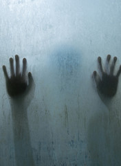 Fototapeta premium Hand person shadow behind translucent mirror stain