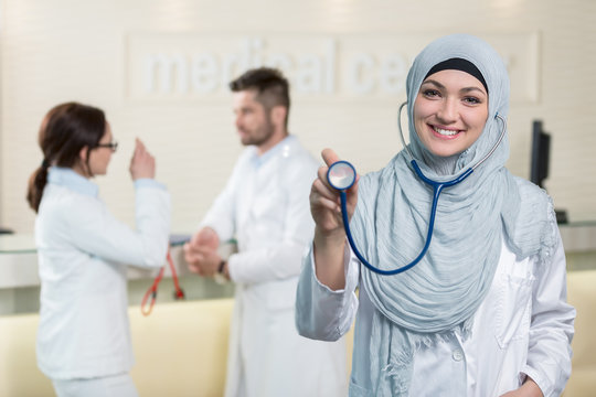 Front view of an arab doctor woman showing stethoscope.